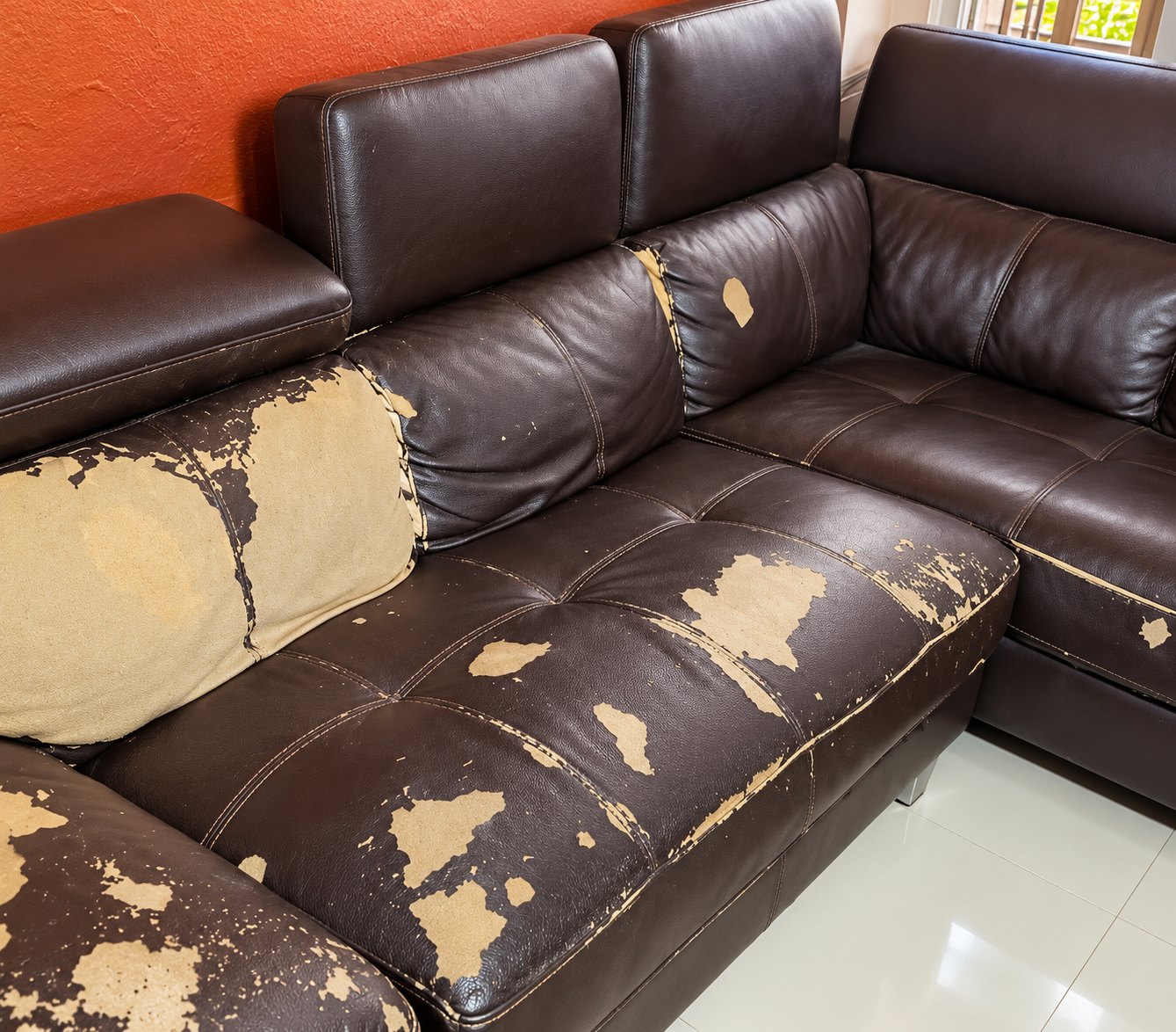Leather L shape sofa before repair, worn and torn
